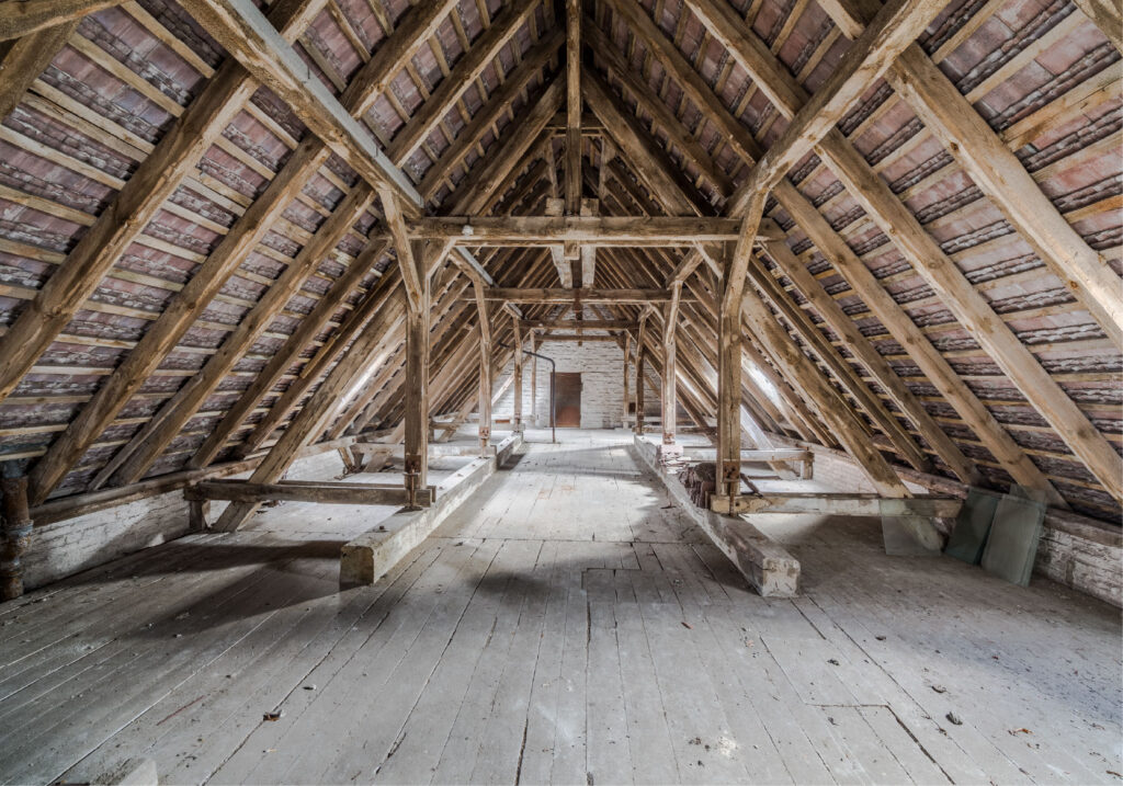 An empty attic space with exposed framing.